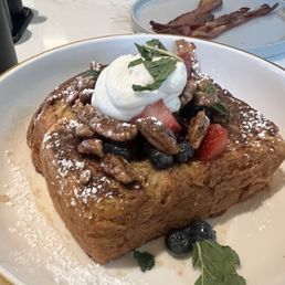 French toast with berries and whip cream. It comes with syrup already on it but I asked for additional syrup on the side French toast with berries and whip cream. It comes with syrup already on it but I asked for additional syrup on the side