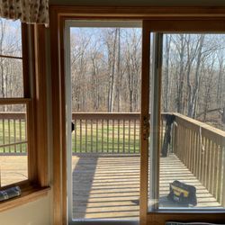 American Home Screens - Looking out of a slider screen door installed with brand new Ultravue mesh in Thomaston, CT