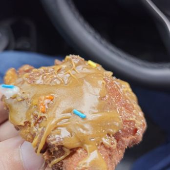 Randall Bakery - a person holding a donut with caramel and sprinkles - Bakeries Near Me - Wakefield, Michigan Randall Bakery - a person holding a donut with caramel and sprinkles - Bakeries Near Me - Wakefield, Michigan