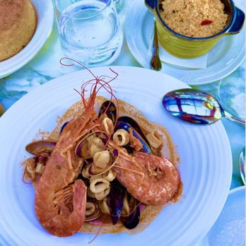 Dora Ristorante - Cous Cous di Pesce...prawns, calamari, clams, mussels in a Mediterranean seafood broth and the cous cous in a mini Le Creuset - Italian Near Me - La Jolla, California Dora Ristorante - Cous Cous di Pesce...prawns, calamari, clams, mussels in a Mediterranean seafood broth and the cous cous in a mini Le Creuset - Italian Near Me - La Jolla, California