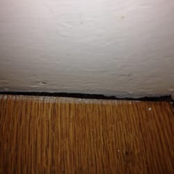 Frank Cole Building Company - Visible gap where riser is pulling away from staircase molding. Every step is affected and has worsened since the addition.