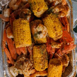 a tray of seafood and corn a tray of seafood and corn