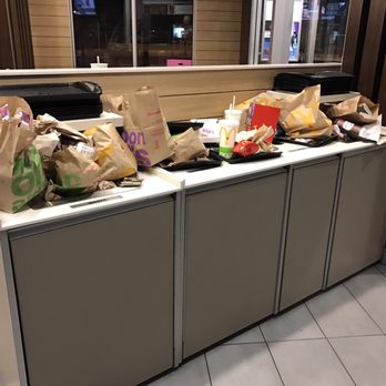 McDonald's - a counter with bags of food on it - Fast Food Near Me - Toronto, Ontario
