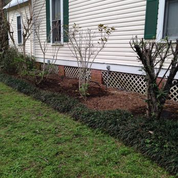 Jared's Yard Care - a white house with green shutters - Landscaping Near Me