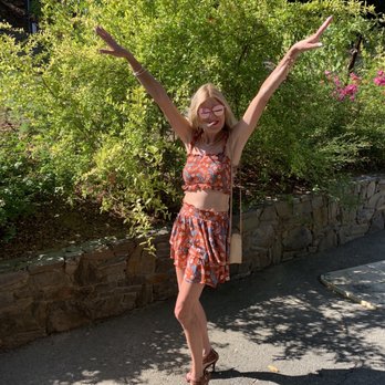 Thomas George Estates - a woman with her arms outstretched in the air - Wineries Near Me - Healdsburg, California