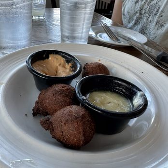 Foster's Kitchen Waikoloa - Hush puppies appetizer with honey butter and Cajun sauce - American Near Me - Waikoloa, Hawaii