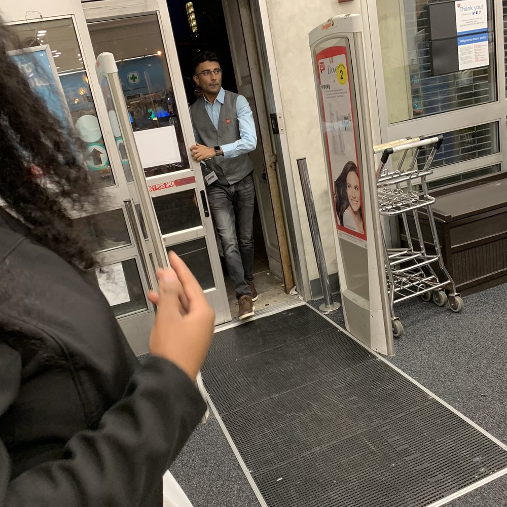 a woman entering a store a woman entering a store