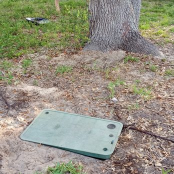 Frontier Internet - Lid of buried fiber optic box left unlocked and ajar. Small children play near this. - Telecommunications Near Me