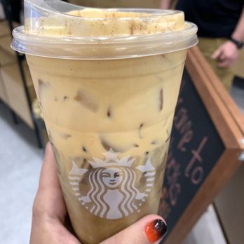Starbucks - a hand holding a cup of iced coffee - Coffee & Tea Near Me - Fayetteville, North Carolina Starbucks - a hand holding a cup of iced coffee - Coffee & Tea Near Me - Fayetteville, North Carolina