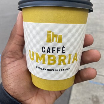 Caffe Umbria - a hand holding a cup of coffee - Coffee & Tea Near Me - Portland, Oregon