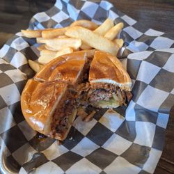 The Outlaw Bar & Grill - The gunslinger, a spicy sausage patty on an Angus patty with bacon, grilled onions and an excellent BBQ sauce!