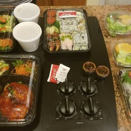 Couple of take out teriyaki salmon dinner boxes along with orders of sushi, sashimi, and rolls. They pack them pretty nicely.