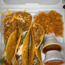 four tacos in a styrofoam container four tacos in a styrofoam container