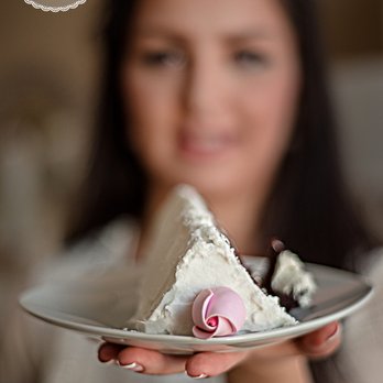 Maryam's Cakery - a woman holding a piece of cake - Desserts Near Me