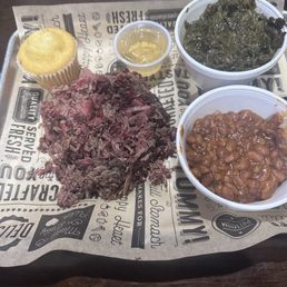 Brisket with collards and baked beans. Brisket with collards and baked beans.