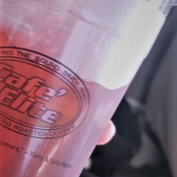 Cafe Elite - a person holding a plastic cup with a drink in it - Coffee & Tea Near Me - Lakewood, Washington Cafe Elite - a person holding a plastic cup with a drink in it - Coffee & Tea Near Me - Lakewood, Washington
