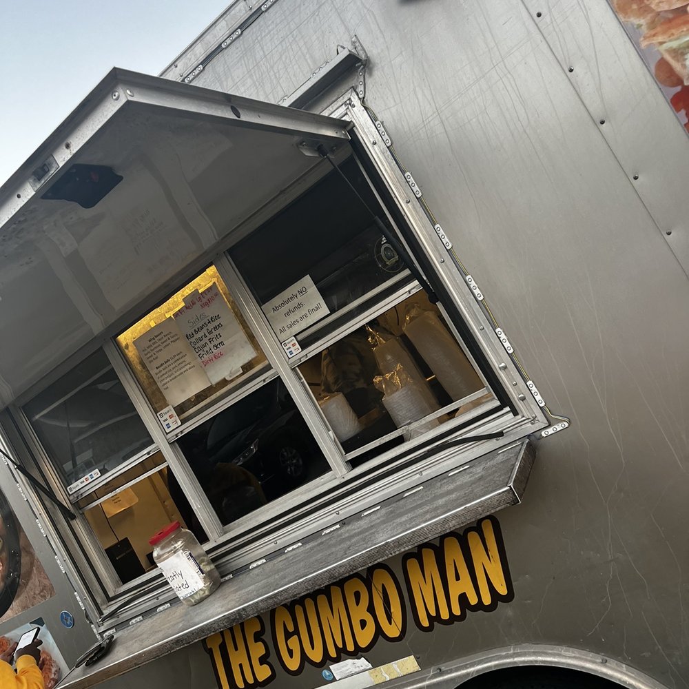 a man standing in front of a food truck