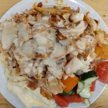 Garlic 'n Lemons - Chicken shawarma plate with Greek salad, hummus, garlic sauce, and chicken topped with tahini - Middle Eastern Near Me - Boston, Massachusetts