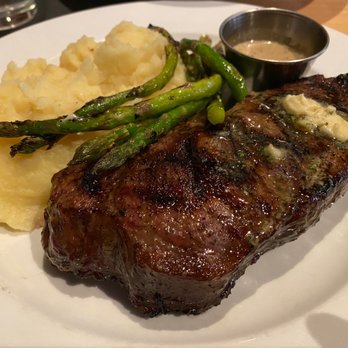 Christopher's Kitchen and Bar - Prime. New York strip steak served with mashed potatoes, grilled asparagus, and a peppercorn sauce. - American Near Me - Woonsocket, Rhode Island Christopher's Kitchen and Bar - Prime. New York strip steak served with mashed potatoes, grilled asparagus, and a peppercorn sauce. - American Near Me - Woonsocket, Rhode Island