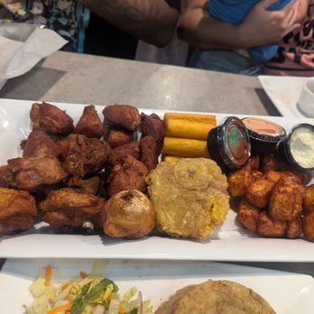 El Cilantrillo - Old Town - Surtido "El desmayo" Fried pork chunks, fried chicken, tostones, pork sausages, friend cheese and soruyitos. DELICIOUS - Puerto Rican Near Me - Kissimmee, Florida El Cilantrillo - Old Town - Surtido "El desmayo" Fried pork chunks, fried chicken, tostones, pork sausages, friend cheese and soruyitos. DELICIOUS - Puerto Rican Near Me - Kissimmee, Florida