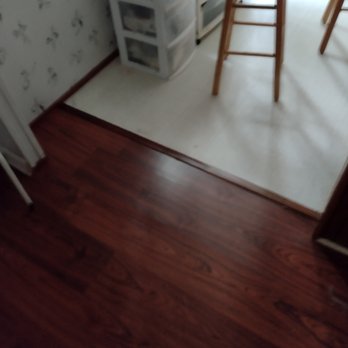 Cinar Interiors - a kitchen with a counter and stools - Carpeting Near Me - Boerne, Texas