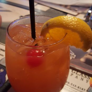 Stripes Pub & Grill - Check Six - rum cocktail with orange and pineapple pieces with a splash of grenadine - American Near Me - Navarre, Florida Stripes Pub & Grill - Check Six - rum cocktail with orange and pineapple pieces with a splash of grenadine - American Near Me - Navarre, Florida