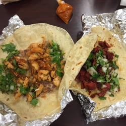 One taco with chicken, one al pastor. Total $3.90