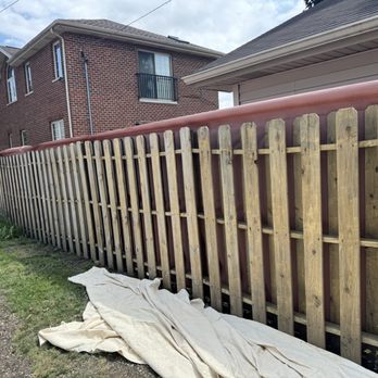 Alex Star Service - Painting the fence with a spray gun - Handyman Near Me
