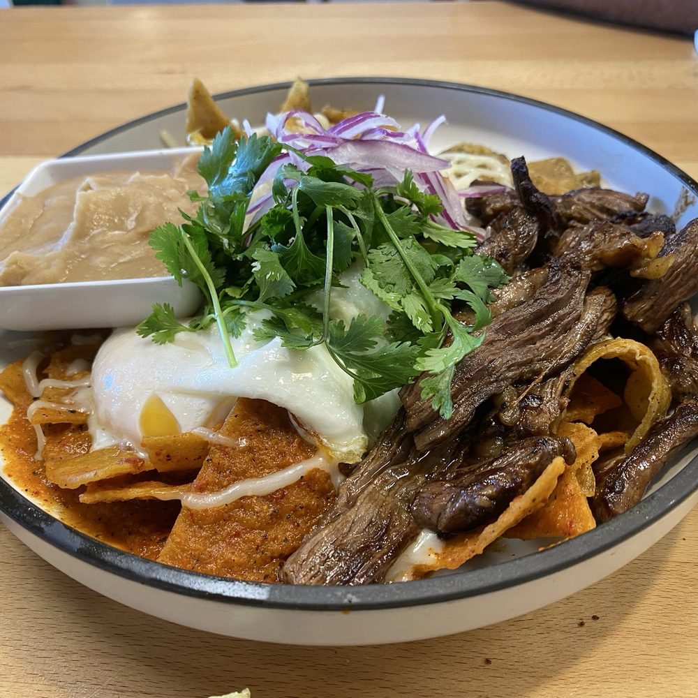 chilaquiles half red half green with asada chilaquiles half red half green with asada