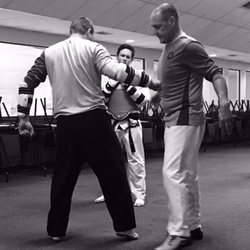 Axiom Martial Arts - Mr Tyler demonstrating cover punch with Mr Caleb.