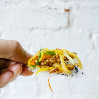 Sen Saigon - a hand holding a piece of food - Vegan Near Me - New York, New York