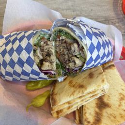 Chicken Shawarma with a side of pita bread. Chicken Shawarma with a side of pita bread.