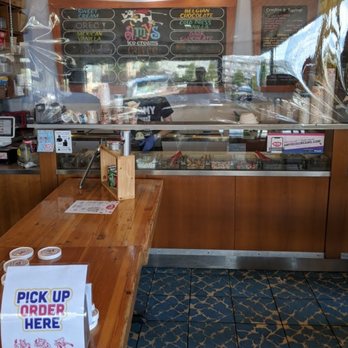 Amy's Ice Cream - a wooden table with a sign on it - Ice Cream & Frozen Yogurt Near Me - Austin, Texas