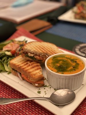 Photo of Green Door Cafe - La Jolla, CA, US. Pesto Panini Plate (Vegan) with carrot ginger soup & 'Citrus' Salad (Vegan & Gluten Free)