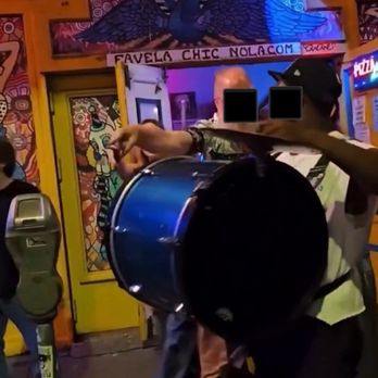 Favela Chic - A possible employee attempting to direct a street band member away from the front of the bar while on public property (sidewalk) - Pizza Near Me - New Orleans, Louisiana
