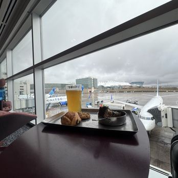 Capital One Lounge at Denver - Behind the bar, seats with a view of the tarmac. - Airport Lounges Near Me - Denver, Colorado