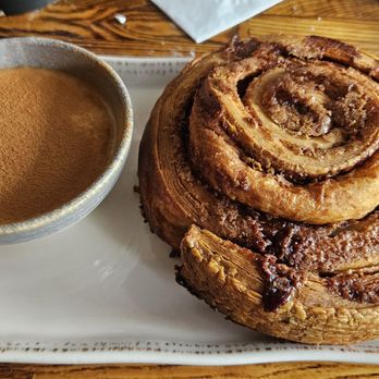 Bosscat Kitchen & Libations - The ultimate cinnamon roll was huge. It was light croissant dough which I liked. It came with a nice cream cheese frosting with cinnamon. - New American Near Me - Irvine, California Bosscat Kitchen & Libations - The ultimate cinnamon roll was huge. It was light croissant dough which I liked. It came with a nice cream cheese frosting with cinnamon. - New American Near Me - Irvine, California