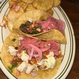Steak and chicken tacos with a side of waffle fries