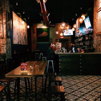 Centro - a man sitting at a bar in a restaurant - Bars Near Me - Lexington, Kentucky