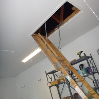 REM Home Inspections - Pull down attic stairs in a garage, compromises fire integrity of house-garage fire assembly, potential fire hazard - Home Inspectors Near Me - Springfield, Virginia