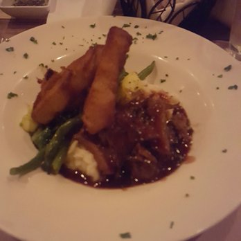 RUVO - Short ribs with horseradish mashed spuds, veggies and fried onion rings. - Italian Near Me - Greenlawn, New York