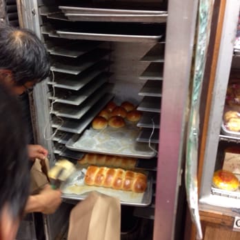 Eastern Bakery - Getting it hot out of the bread warmer thing - Bakeries Near Me - San Francisco, California
