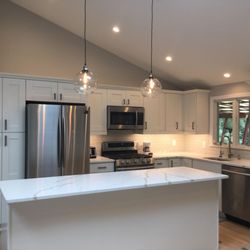 Crown Stone & Cabinets - Townhouse in Greenwich with traditional white shaker design and calacatta bella countertop