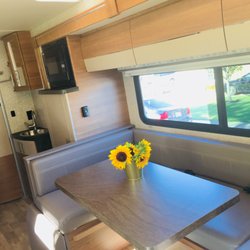 Road Shark RV - Prefect dining lounge, transforms into bed (42" x 82"), foot rest, large sliding window, with blackout and privacy shades.