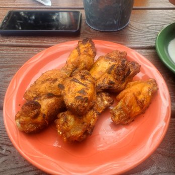 Peegeos - a plate of chicken wings on a table - Pizza Near Me - Traverse City, Michigan Peegeos - a plate of chicken wings on a table - Pizza Near Me - Traverse City, Michigan
