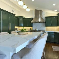 Di Franco Stone Specialist - White Venatino Quartz perimeter counters with Fantasy Gold Quartz Full High splashes up to ceiling behind Hood and 2" Miter Edge.  Gold vein