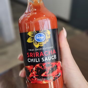 The One Pho - a hand holding a bottle of chili sauce - Vietnamese Near Me - Austin, Texas The One Pho - a hand holding a bottle of chili sauce - Vietnamese Near Me - Austin, Texas