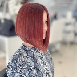 Up On Sunset - Unleash your inner boldness with this vibrant red short hair color and bob haircut, radiating confidence and showcasing a modern twist.
