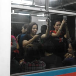 MRT Boni Station - People on the train