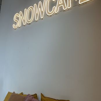 Snowcapz - a bed with pillows and a neon sign - Desserts Near Me - Calgary, Alberta Snowcapz - a bed with pillows and a neon sign - Desserts Near Me - Calgary, Alberta